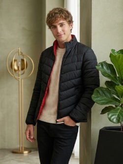 Men's black winter bomber jacket with padded design, red lining, and zip closure.