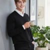Oswal Wool Black Men's black wool sweater layered over a white collared shirt for stylish winter wear.