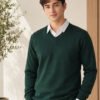 Oswal Wool Green Men's black wool sweater layered over a white collared shirt for stylish winter wear.