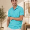 Lagoon Mist Men’s polo T-shirt with contrast collar and sleeve detailing, paired with light trousers for a fresh casual look.